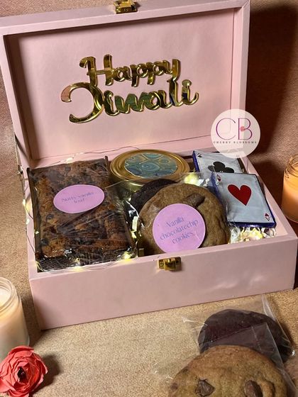 Add sweetness to your Diwali with our special confectionery hamper. This pink box is filled with a nutty vanilla loaf, choco-chip cookies, and a variety of our handmade chocolates.