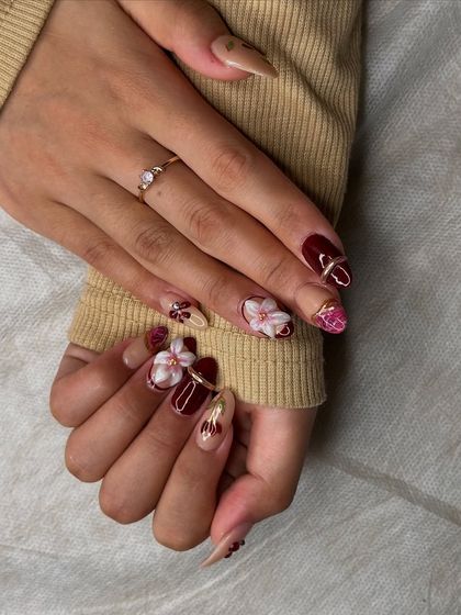 This angle shows the mix of textures and finishes, from glossy burgundy to matte nude with 3D floral accents.