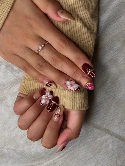 This angle shows the mix of textures and finishes, from glossy burgundy to matte nude with 3D floral accents.