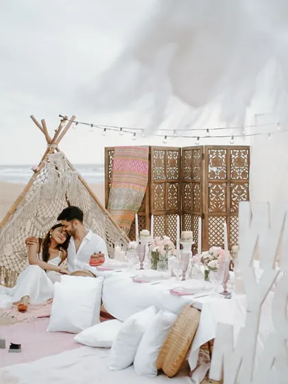 We create more than just photoshoots; we design experiences. For Jash and Hiral, we set up this dreamy picnic on a serene Goa beach, a beautiful setting for them to relax and create authentic memories together.