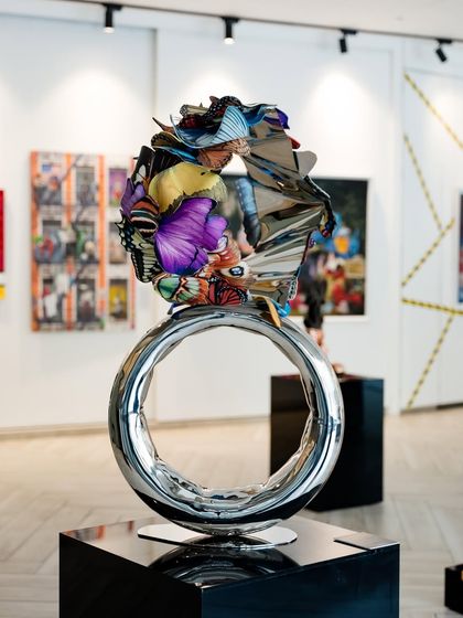 The "Flight to Infinity" sculpture as a centerpiece in the gallery, a testament to harmonious design and symbolic artistry.