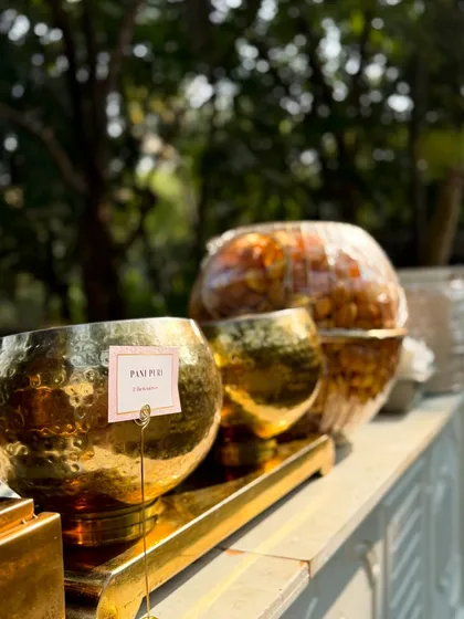 A glimpse of my catering setup for Aniket and Akshay's special day. The elegant golden serveware and clean white counters reflect the luxury and care I put into every event.