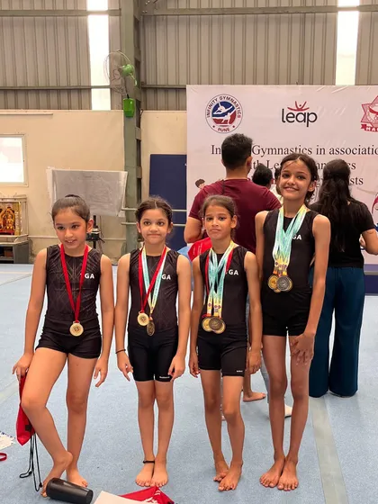 Our team of young champions, proudly wearing their medals after a successful competition. The future of Indian gymnastics is bright.