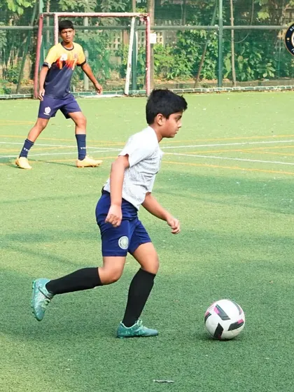 A young player from our academy dribbles the ball with focus during a match against Thane City FC. Competing in national tournaments like The Winter Cup tests and develops our players' skills under pressure.