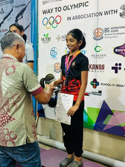 A young competitor receives her medal from G. Susheel, the Honorary Secretary of the Karnataka State Rifle Association, during our open competition.