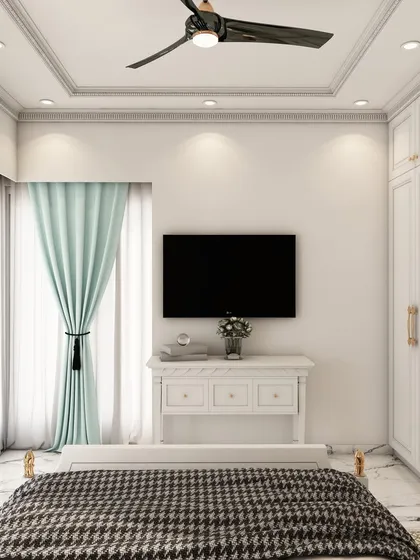 A view of the same traditional bedroom, showing the classic white wardrobe with mirrored panels and a simple, elegant TV console.
