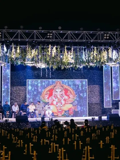 The grand stage setup for a Sangeet, with a large LED screen and ample seating for guests to enjoy the performances.