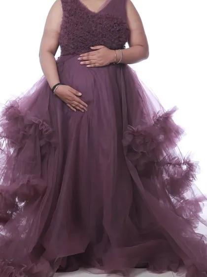 A mauve pastel ruffle gown that is both elegant and comfortable. The layers of ruffles add texture and movement, creating a beautiful silhouette.