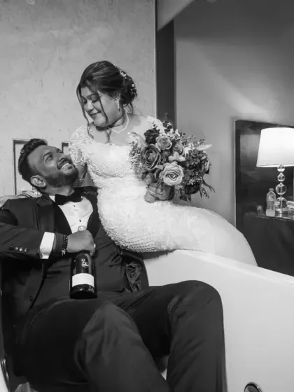 Who needs a dance floor? A fun and quirky portrait of the couple sharing a laugh and a drink in a bathtub. It's all about creating unique memories!