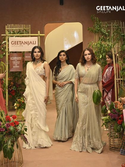 The runway at our Ahmedabad salon, surrounded by guests and beautiful floral arrangements.