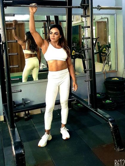 Posing by the Smith machine in an all-white outfit. Strong is the new beautiful.