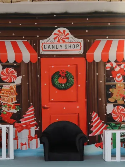 Our festive Christmas candy shop set, complete with striped awnings, gingerbread decorations, and a tiny armchair for the star of the show.