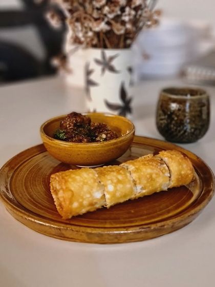 My Rakhi gift hampers are perfect for food lovers. Here, the amber-glazed plate and bowl are shown serving a delicious snack, making for a beautiful presentation.