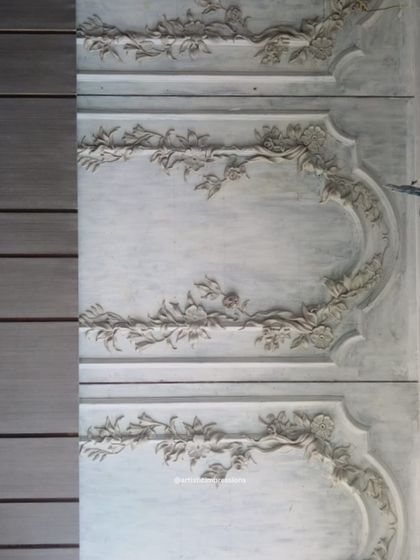 The completed South Mount mural installed on the wall. The heritage-inspired design features elegant floral garlands that frame the panels, creating a sophisticated and classic look.