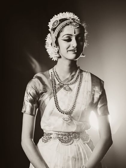 A beautiful portrait of a classical dancer. The sepia tone and soft backlighting create a nostalgic and timeless feel.