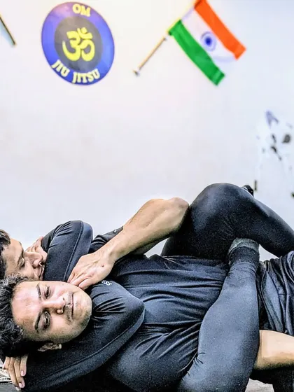 This is the chess match of martial arts. A student works to secure a rear-naked choke, a fundamental Brazilian Jiu-Jitsu technique that relies on precise control and leverage to safely subdue an opponent without strikes.