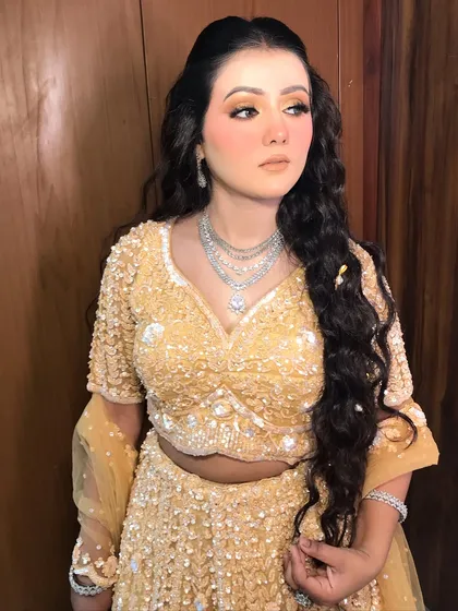 This engagement bride is glowing in her yellow lehenga, paired with a beautiful layered American diamond necklace.