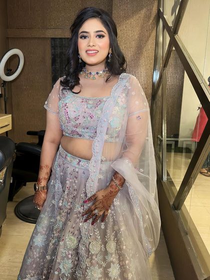 A happy and gorgeous client. Her smile is the best accessory to this beautiful party look in a pastel lehenga.