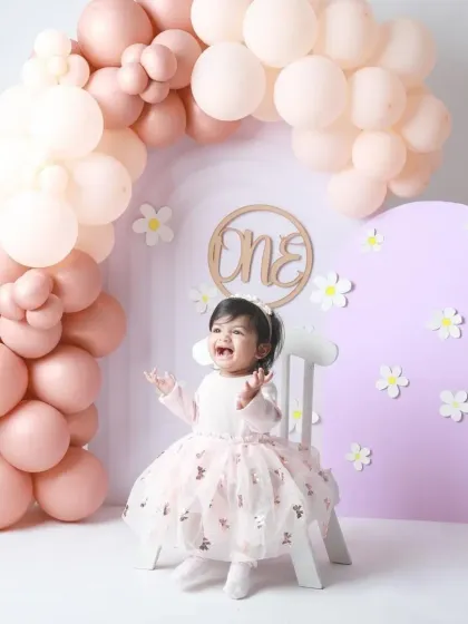 Pure excitement! This little princess is all smiles, celebrating her first birthday with a gorgeous pastel balloon setup.