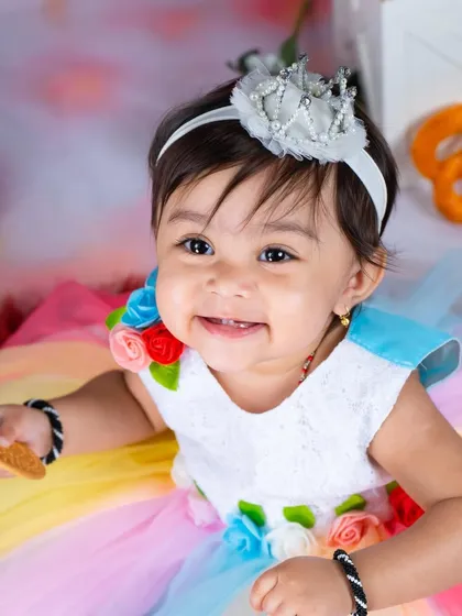 Welcome to cookie land. This sweet theme is filled with colorful donuts, cookies, and a rainbow dress for a truly delicious-looking photoshoot.