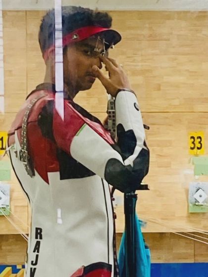 A candid shot of our shooter Rajveer, focused and in the zone during a competition.
