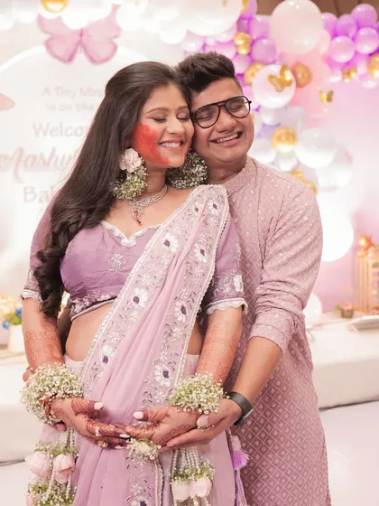 The happy couple at the baby shower, with the mom-to-be glowing.