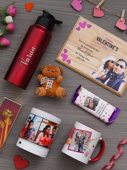 A flat-lay of the all-in-one Valentine's combo, showing the personalized wooden frame, Bluetooth speaker, custom mug, and other romantic gifts.