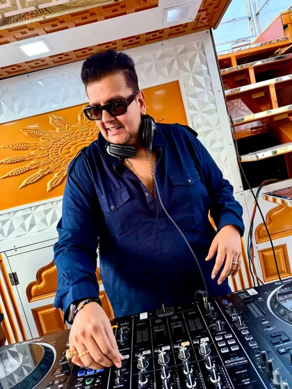 A close-up shot of me working the mixer. Every twist of a knob is intentional, crafting a seamless flow of music that keeps the dance floor packed.