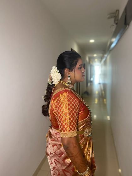 A side profile of the bride, showcasing how the hairstyle complements her overall look.