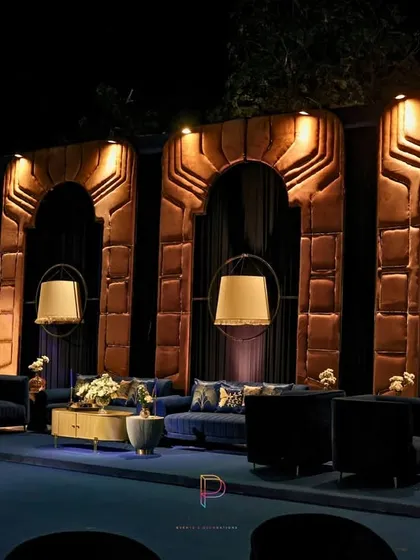 For this lounge area, we designed custom arched wall panels with a golden texture to evoke a sense of heritage architecture. Paired with modern pendant lamps and plush velvet seating, it became the perfect regal unwind zone.