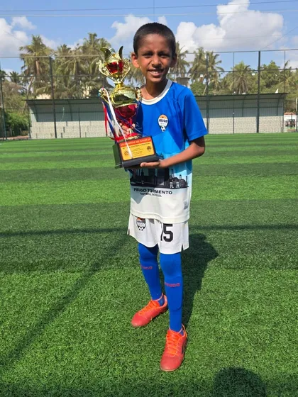 A proud member of our U12 team holding his championship trophy.