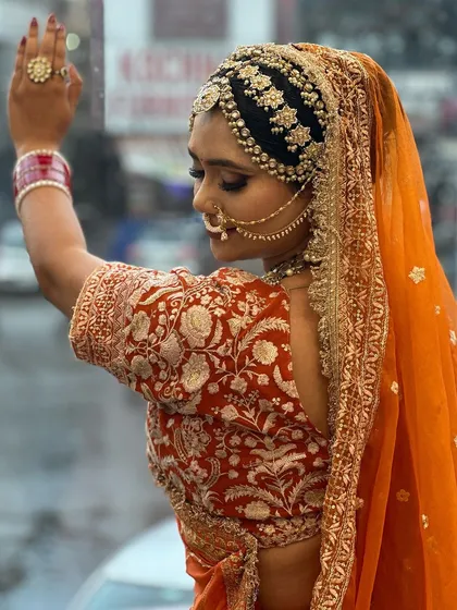 Another angle of our Marwadi bride, showing how the entire look comes together with the pose and lighting. The side profile highlights the beautiful embroidery on her blouse and the elegant drape of the dupatta.