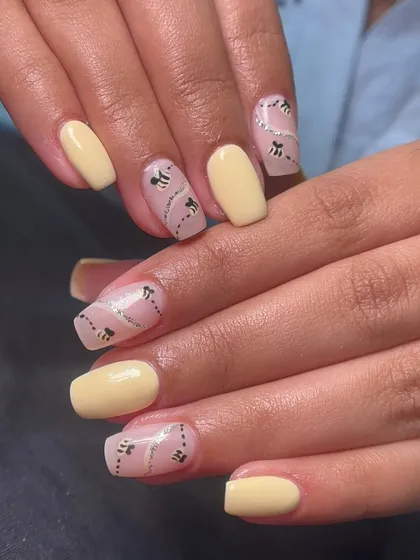 How cute is this honeybee nail art? I hand-painted the tiny bees and their flight paths over a sheer, glittery base, paired with solid pastel yellow nails.