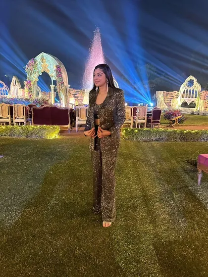 This olive green sequin co-ord set, featuring a blazer and matching flared pants, was designed for a destination wedding's welcome dinner. It's a glamorous and comfortable choice that makes a lasting first impression.