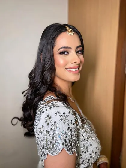 A side profile showing the soft waves and the beautiful, natural makeup that enhances her features.
