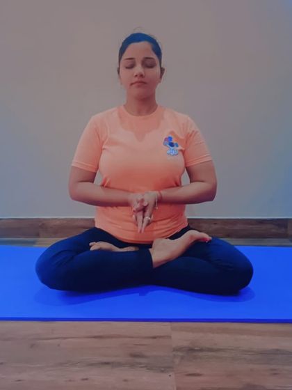 The practice of Yoga Mudra in Padmasana. This pose combines a deep forward bend with the stability of the lotus posture, which aids in relieving anxiety by stimulating abdominal organs and bringing a sense of grounding.