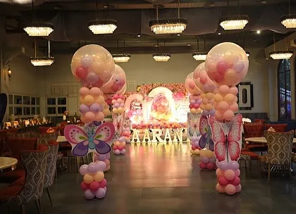 We extended the butterfly theme throughout the venue with these beautiful balloon pillars topped with large butterfly cutouts, creating a cohesive and magical atmosphere.