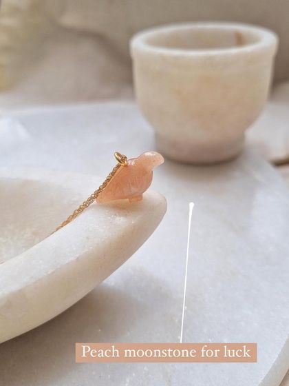 The Peach Moonstone Dove pendant, a beautiful piece for luck.
