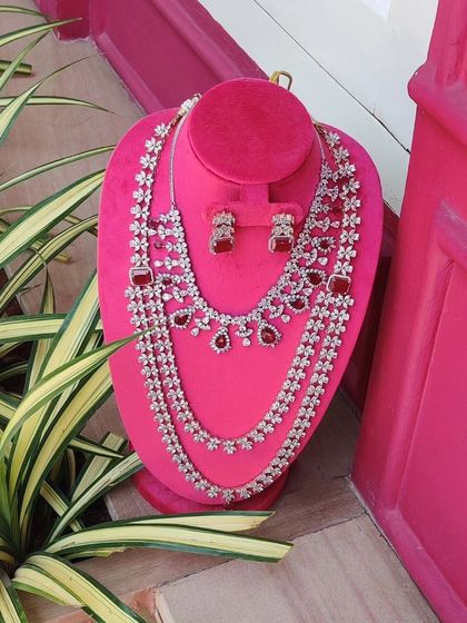 A sparkling diamond and ruby layered necklace set, perfect for adding glamour to a reception gown or lehenga.