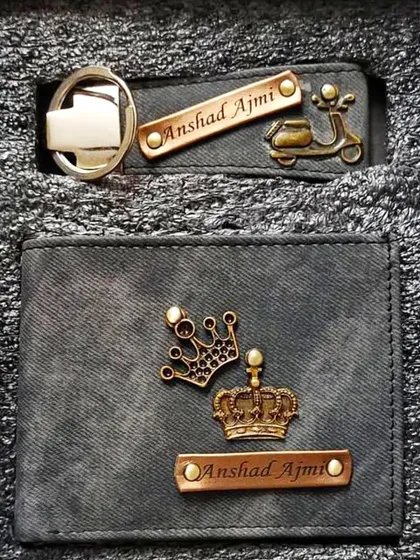 This personalized gift set in grey denim includes a wallet with multiple crown charms and a matching keychain with a scooter charm.