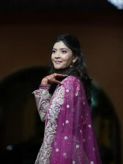 A beautiful candid shot of the bride-to-be at her engagement party. The makeup is soft and romantic, with a focus on enhancing her natural features.