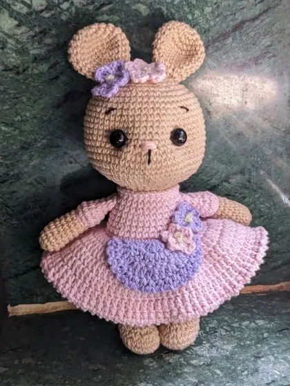 The bunny doll against a marble background.