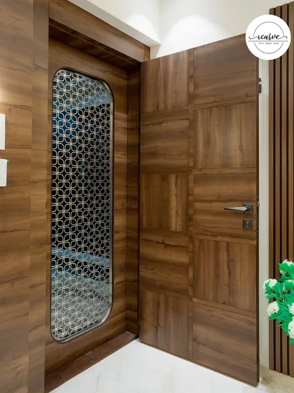 Another angle of the entrance, showcasing the beautiful wood grain and the intricate pattern of the safety door grill.