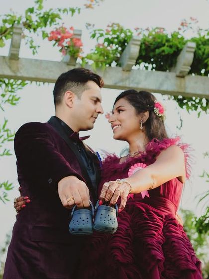 Announcing the little one's arrival with a pair of tiny shoes. This is a creative and heartwarming shot, perfect for any maternity session.