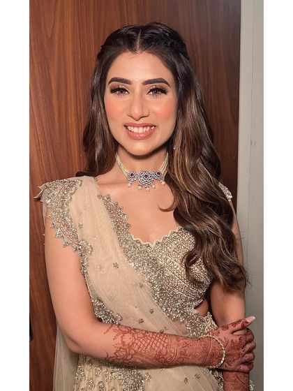 The happy bride showcasing her engagement hairstyle. The half updo with soft waves is a flattering choice that highlights her features and her beautiful smile.