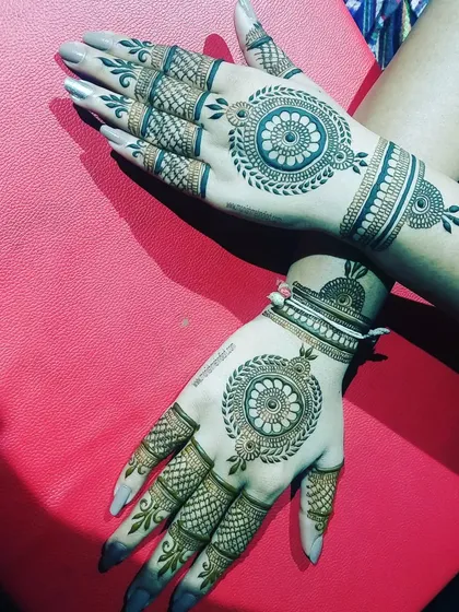 A classic mandala design on both hands. The intricate net pattern on the fingers complements the central mandala perfectly.