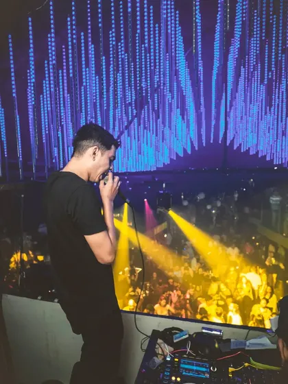 From the booth, I see a sea of energy. This is my view of a packed house, with everyone lost in the music under the lights. This connection with the crowd is what I live for.