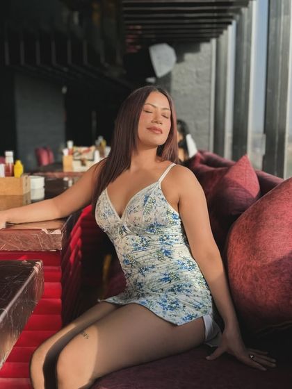 A floral blue and white mini dress, perfect for soaking up the sun at a rooftop cafe.