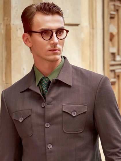 A close-up from the Only Vimal campaign, focusing on the details. The combination of the textured suit fabric, the green shirt, and the patterned tie creates a layered and sophisticated menswear look.