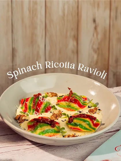 My Spinach Ricotta Ravioli is as beautiful as it is delicious. The colorful pasta is stuffed with creamy ricotta and spinach, served in a light sauce.